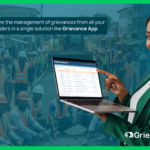 Professional woman showing Grievance App interface on laptop, representing centralized management of multi-project grievances on large infrastructure projects