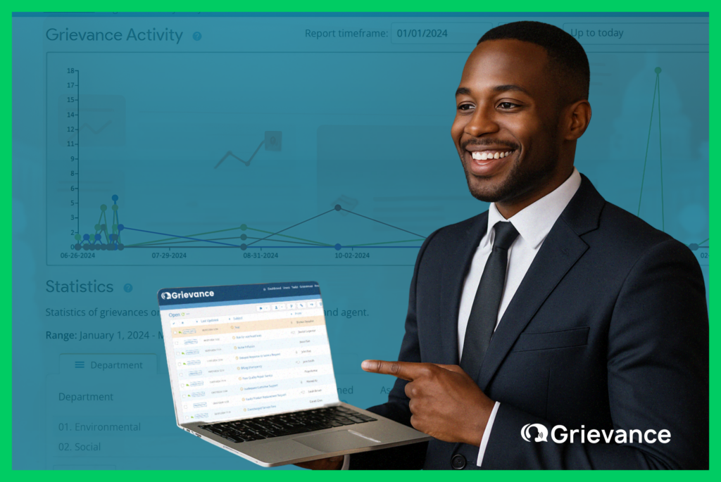 Real Time Grievance Tracking Dashboard – Grievance App A smiling project manager in a suit presenting a laptop screen with the Grievance App dashboard, highlighting real-time grievance tracking charts and statistics.