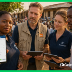 NGO field team using a grievance portal on smartphone and tablets during a community engagement session in a semi-urban area in Africa